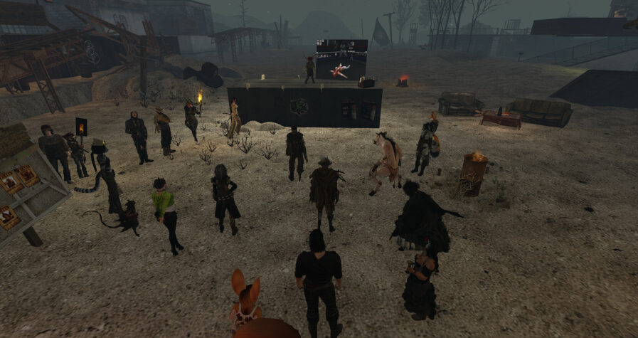 Memorial Service for KittyKat Borkotron Wastelanders gathered to remember KittyKat Borkotron at The Bunker, where candles and a slideshow of images are displayed.